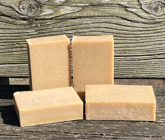 Four rectangular bars of soap on a bench