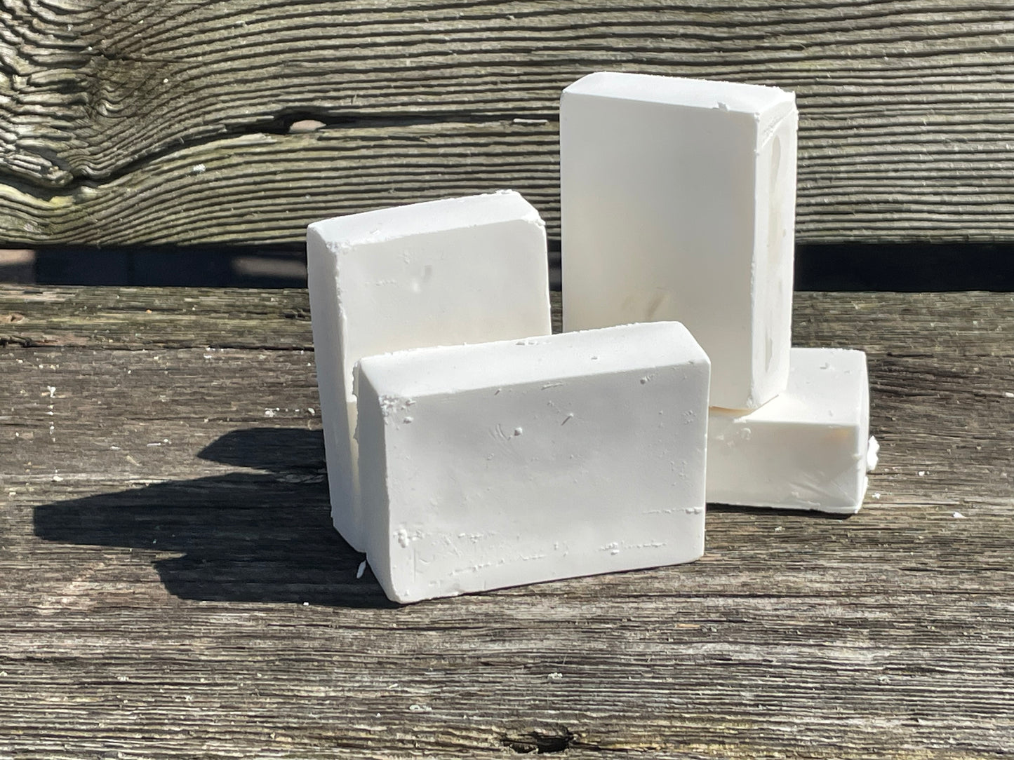 Four bars of Castile soap on a bench