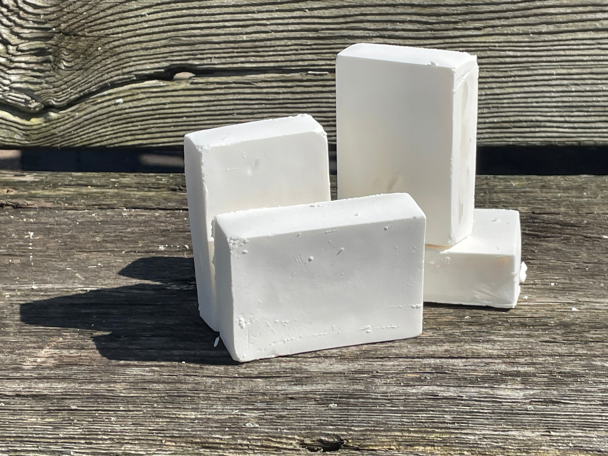 Four bars of Castile soap on a bench