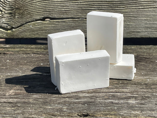 Four bars of Castile soap on a bench